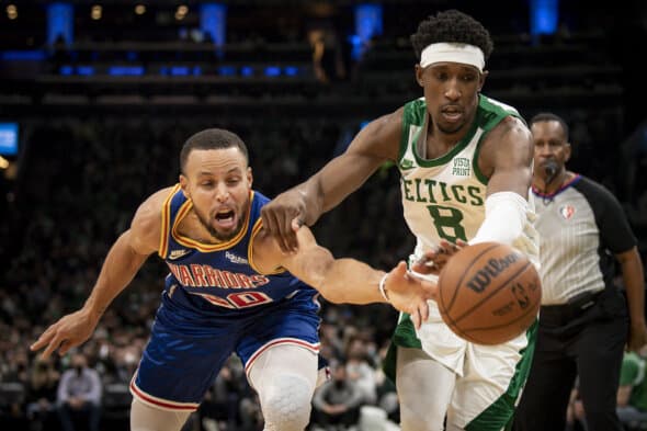 Stephen Curry, jogador do Golden State Warriors, e Josh Richardson, jogador do Boston Celtics, disputam posse bola em jogo na NBA